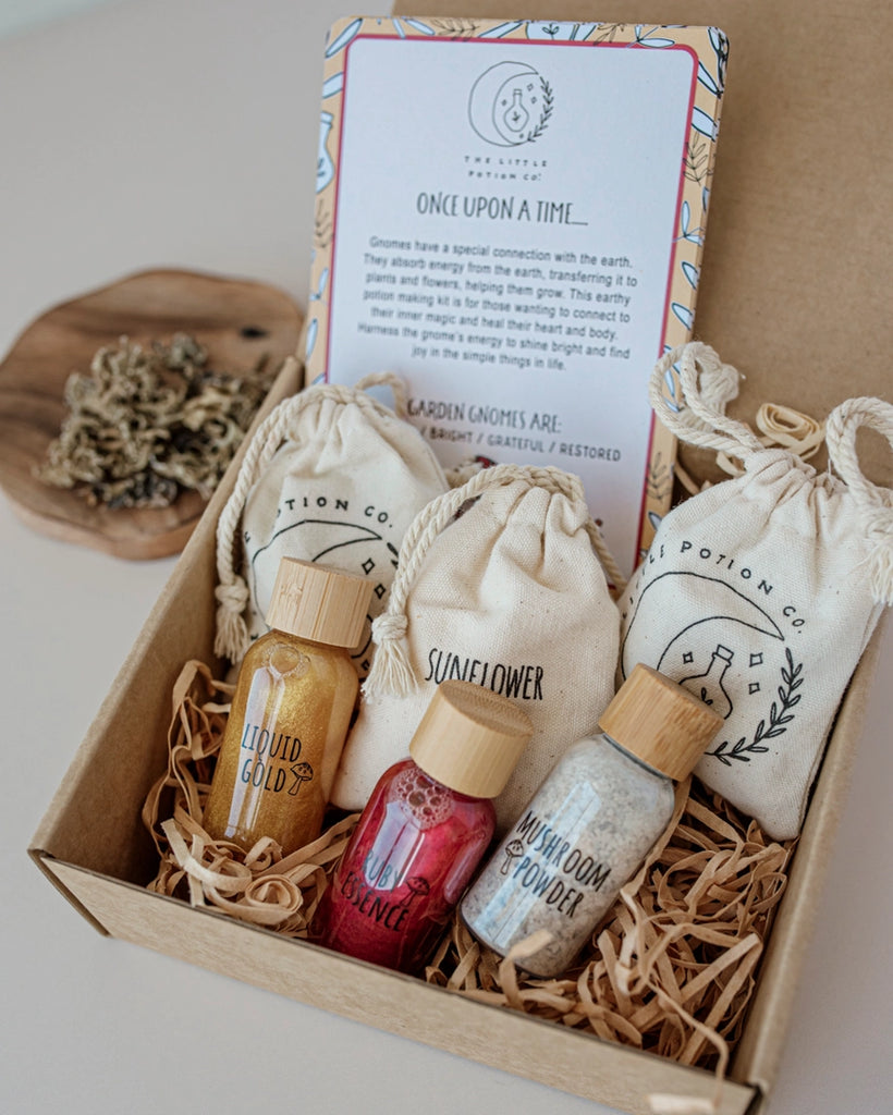 Little Potion Co Gnome Remedy Mindful Magic Potion Kit includes 3 liquids of vibrant colours and full of sparkles in PET bottles with bamboo lids. three bags of dry potion ingredients 3 affirmation cards and one recipe card. Made in Austrailia